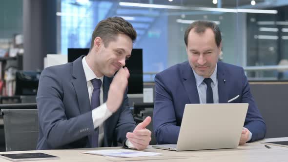 Businessman and Colleague Doing Video Call on Laptop