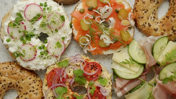 Bagel Sandwiches with Various Toppings, Salmon, Cottage Cheese, Hummus, Ham, Radish and Fresh Herbs