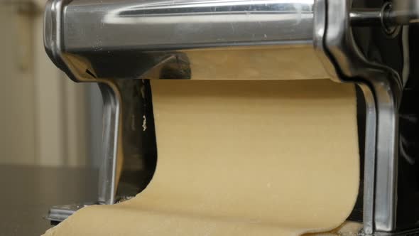 Manual processed lasagna sheets close-up 4K 2160p 30fps UltraHD footage - Dough shaping in pasta mac