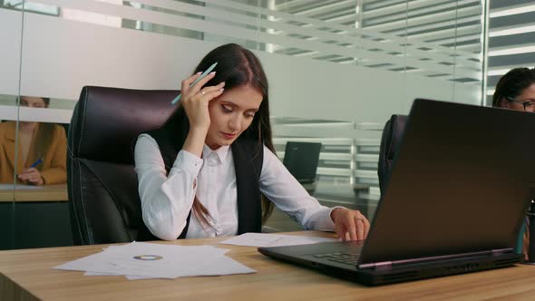 Businesswoman is overwhelmed and feels stressed out at workplace.