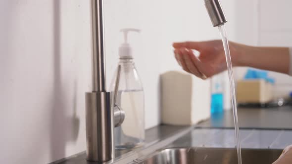 Doctor or Nurse Washing Hands with Liquid Soap