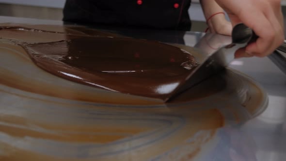 Tempering of the Chocolate on the Metal Surface in the Pastry Shop