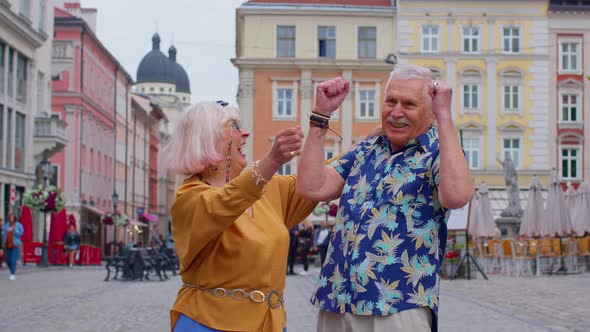 Elderly Stylish Couple Tourists Man Woman Celebrate Success Win Scream Rejoices Doing Winner Gesture
