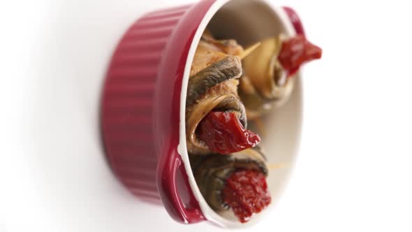 Vertical video: Canned eggplant in a red plate