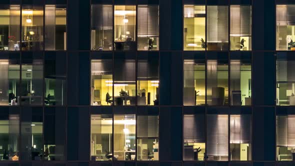 Window of the Multistorey Building of Glass and Steel Lighting and People Within Timelapse