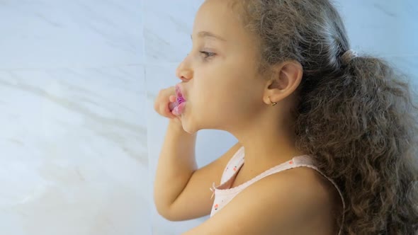 Happy Portrait Cute Caucasian Young Teenage Girl Brushing Teeth in Bathroom. Child Daily Healthcare