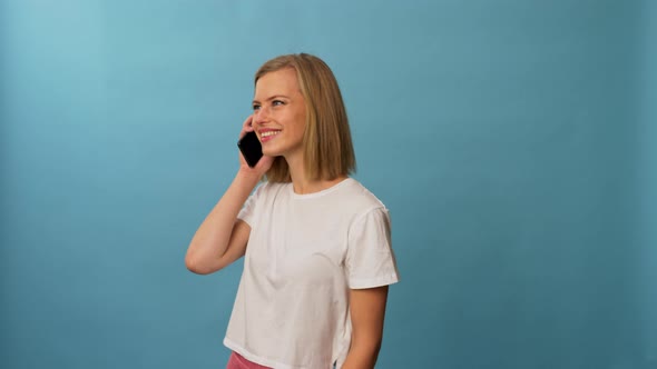 Model Wearing White Shirt Answers Phone on Frame