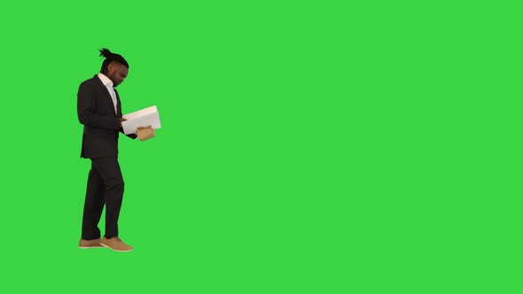 African American Man in Office Suit Walk Looking Into Document on a Green Screen Chroma Key