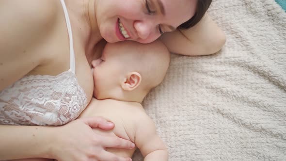 a Mother and the Baby on the Bed