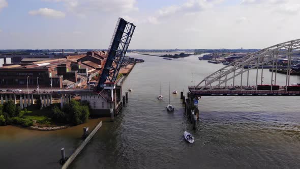 Sailboats Passing By Opened Bascule Bridge In Noord River, Alblasserdam, Netherlands. drone descend