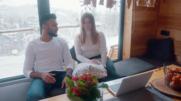 Couple Watching Movie on Laptop in Cozy Home on Winter