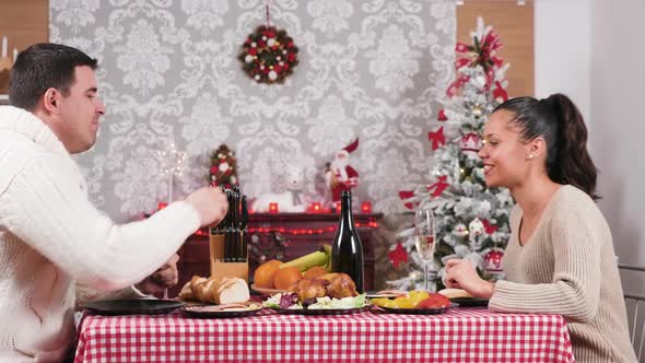 Gorgeous Caucasian Couple Enjoying a Christmas Dinner in Their Living Room
