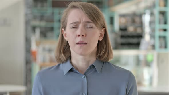 Portrait of Young Woman Sneezing Feeling Unwell