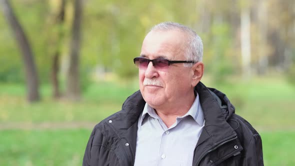 Senior Man with a Mustache in the Park