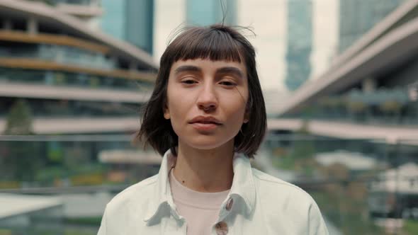 Smiling Woman Posing Near Huge Shopping Mall