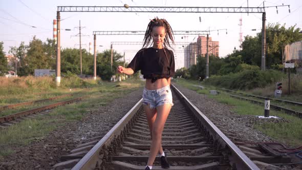 Young Happy Hipster Woman Walking on the Railroad