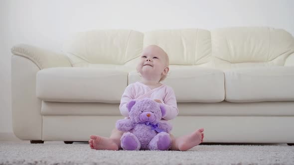 Childhood, Children and Babyhood Concept - Crawling Funny Baby Girl Indoors at Home