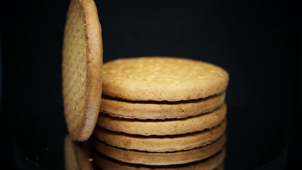 Stack Of Digestive Biscuits Isolated On Black Background. - rotating shot, macro