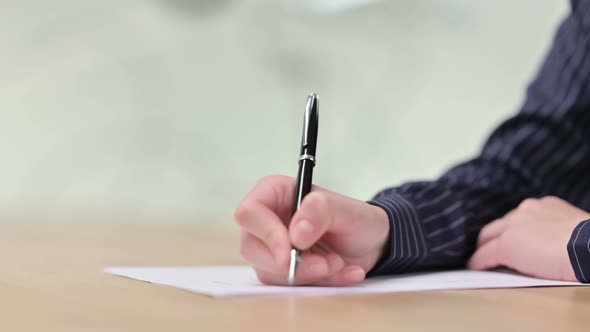 Close Up of Female Hand Writing on Paper