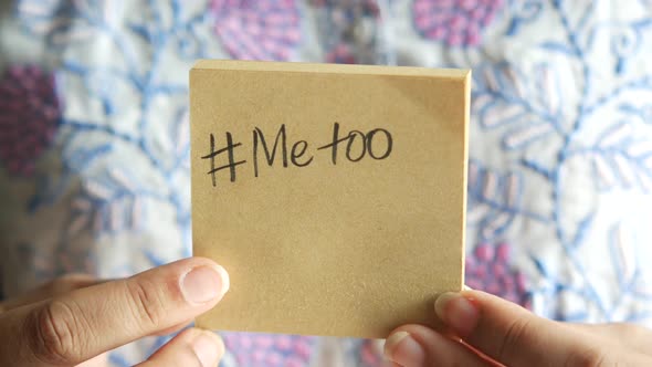 Women Holds a Sticky Notes with Handwritten Me Too Text