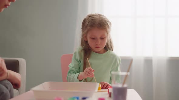 Serious Little Girl Draws Ebru Art with Sister at Workshop