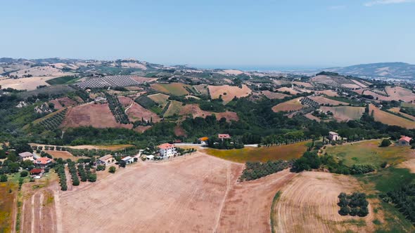 Aerial view of hills and agricultural fields in Marche region, Italy