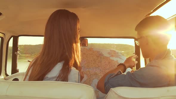 Friends Using Map Traveling In Car In Summer. Handsome Man And Beautiful Woman