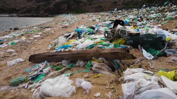 Plastic bags and marine debris littering sandy beach in Vietnam; drone