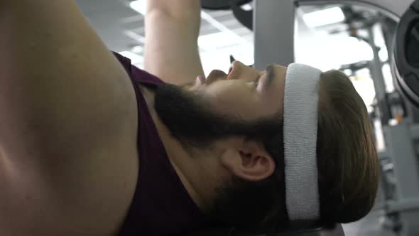 Motivated Fat Man Lifting Gym Barbell Lying on Bench, Desire to Lose Weight