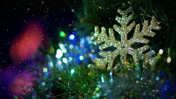 A Christmas Tree Decorated with Golden Snowflake and Shining Lights Against Burning Fireplace