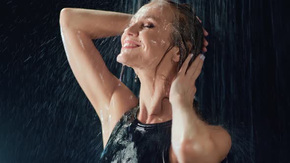 Sensual Lady with Joyful Face Expression Standing Under Rainy Drops