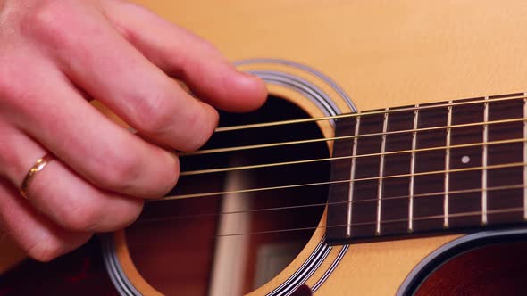 Close Up Man Playing on Guitar at Home Learning and Tune