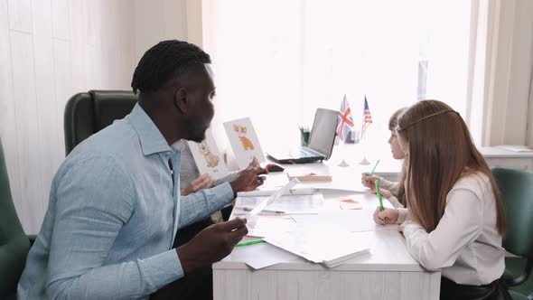 Africanm American Man and Female Teacher Teaching English on Private Lesson