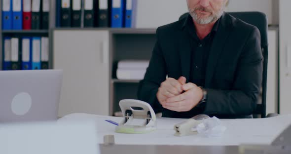 Tensed Overworked Businessman Working in Office on a Project