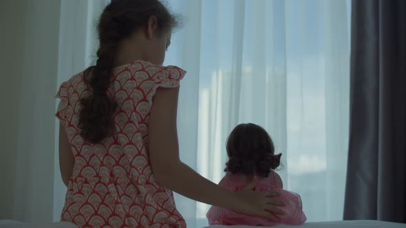 Child Girl in Medical Protective Mask Holding a Teddy Bear at Sunset