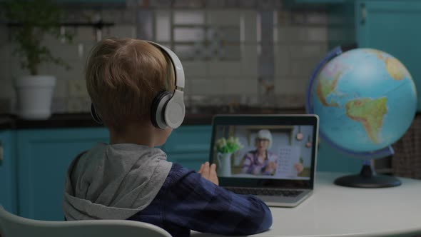 School Boy Studying Math with Senior Teacher Online Using Tablet Computer for Distance Learning From