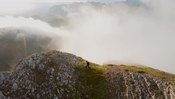 Drone Shot of Hiker on Mountain Cloudy Top