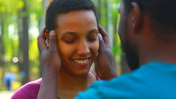 African American Couple Talking Together in Summer Park