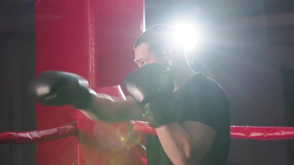 A Young Man Concentrates and Starts Shadow Boxing