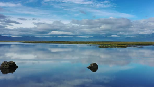 Stones with Reflection in Smooth Water