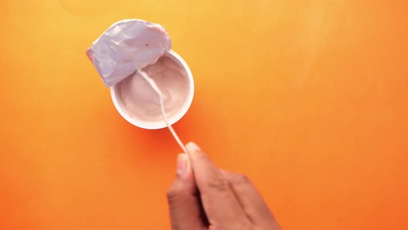 Fresh Yogurt in a Plastic Container on Black Background