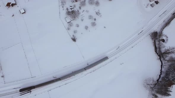 Aerial view of train rolling on winter time