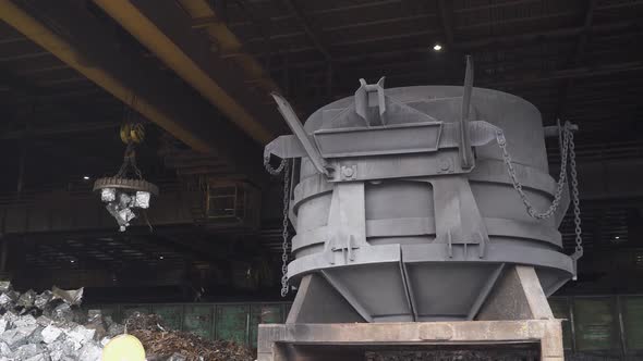 Steelmaking the Process of Loading Scrap Metal Into a Tank for Steel Melting Gantry Cranes with