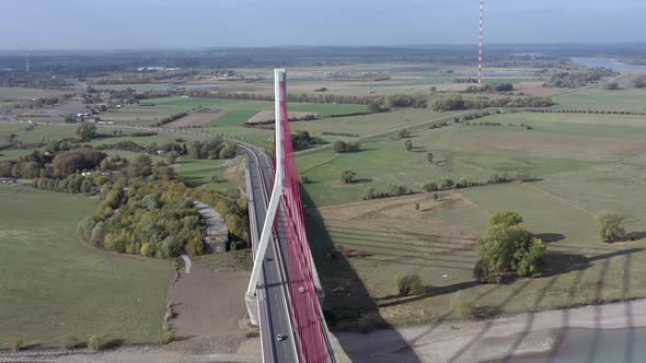 Vehicles Crossing a Cable Stayed Suspension Bridge Crossing a River