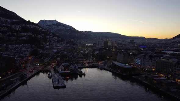Aerial shot towards Bergen downtown through Bergen harbour, Epic first morning lights
