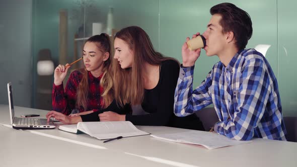 Group of Young Creative Workers in a Creative Start Up Work Environment Holding a Project Meeting