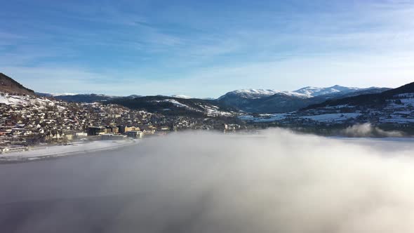 Voss norway seen through beautiful morning haze on top of frozen Vangsvatnet lake - Sidewaysing aeri