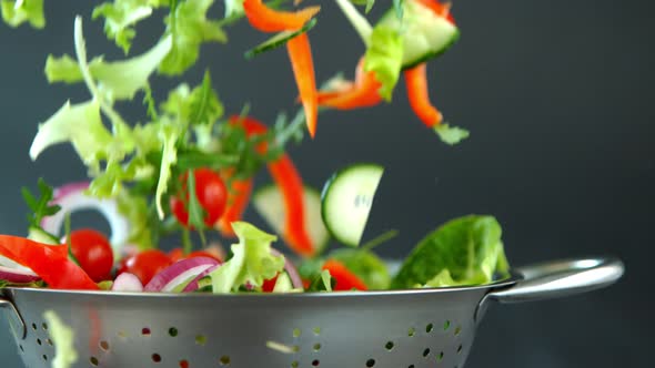 Fresh Salad Flying To Colander in Super Slow Motion.