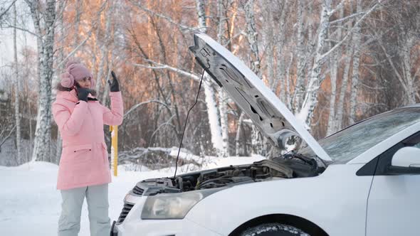 Woman Near Broken Car Calling for Help in Winter