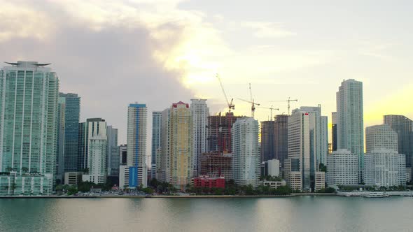 Aerial view of skyscrapers and cranes at dusk